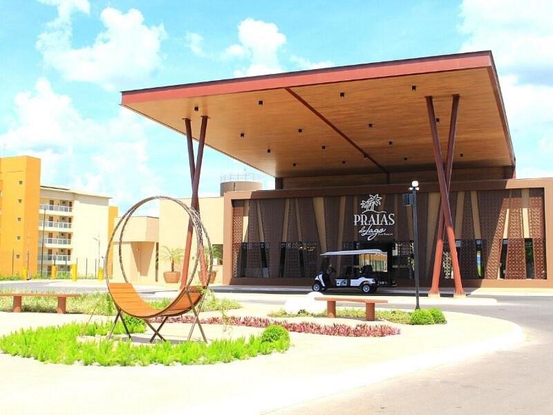 a chair sitting in front of a building at Praias do Lago ECO RESORT Bloco M Térreo in Caldas Novas