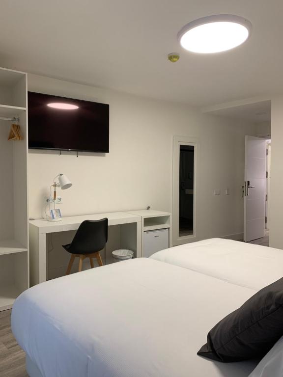 Postel nebo postele na pokoji v ubytování Hostal Comfort Suites