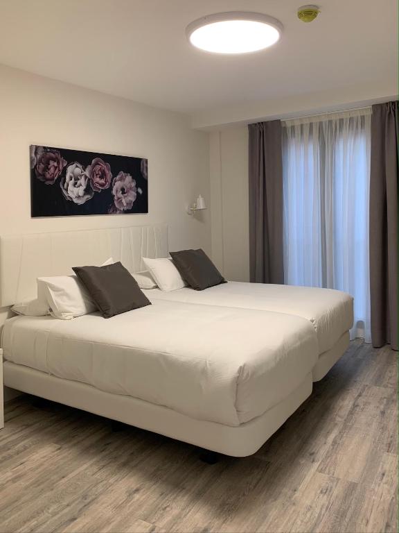 Postel nebo postele na pokoji v ubytování Hostal Comfort Suites