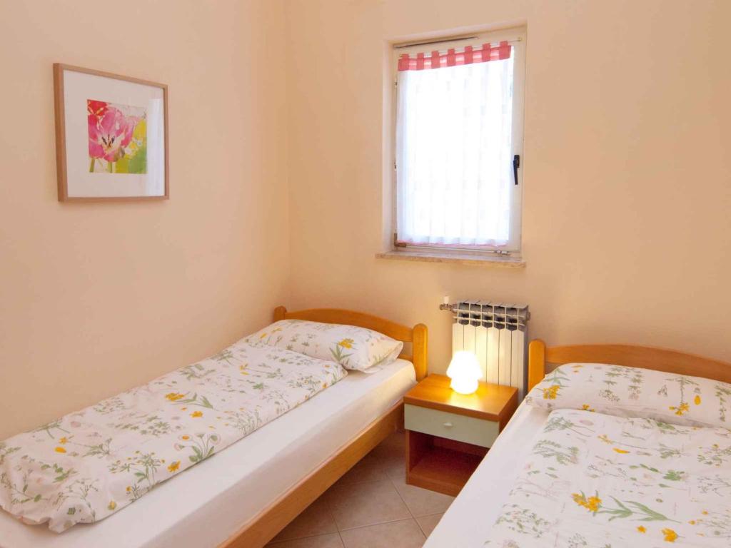 Säng eller sängar i ett rum på Apartment in Rabac 16819