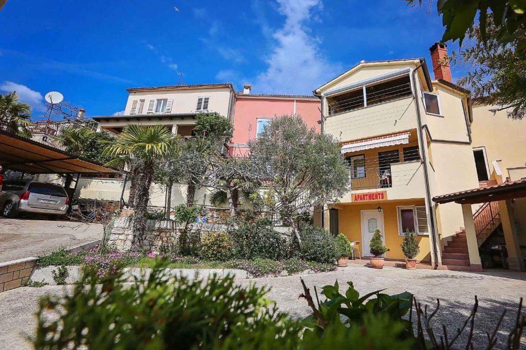 a building on a street with trees in front of it at Studio Apartment in Vrsar I in Vrsar