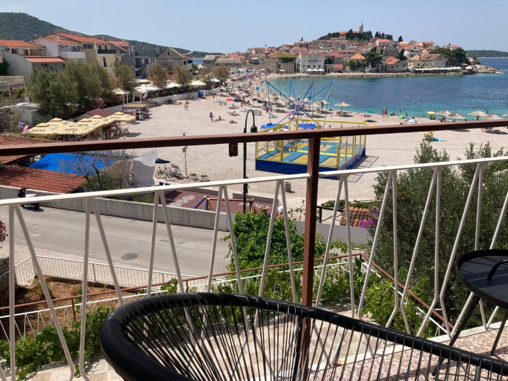 a balcony with a view of a beach and the ocean at Rooms 22 - Beachfront in Primošten
