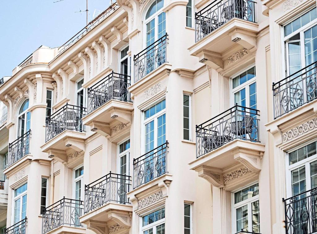 fachada de un edificio de apartamentos con balcones en Le Riviera Collection, Signature Collection by Best Western, en Niza