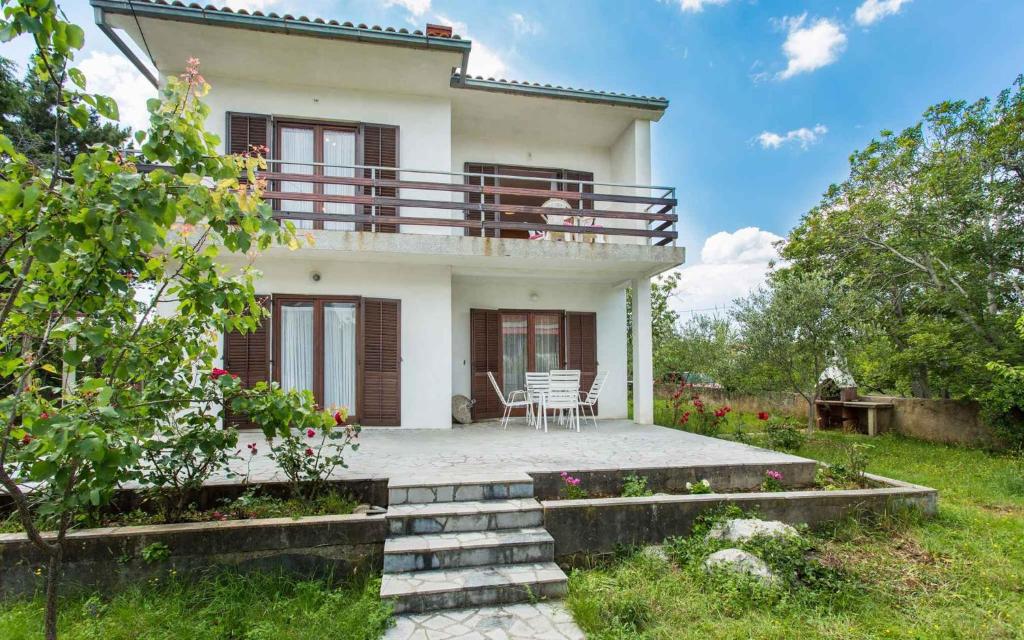 a large white house with a patio in front of it at Apartment in Silo/Insel Krk 13496 in Šilo