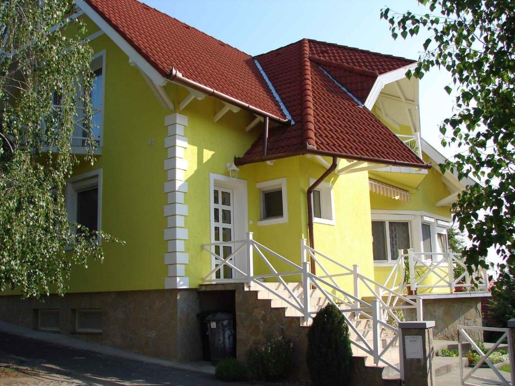a yellow house with a red roof at Apartment in Fonyod/Balaton 18581 in Fonyód