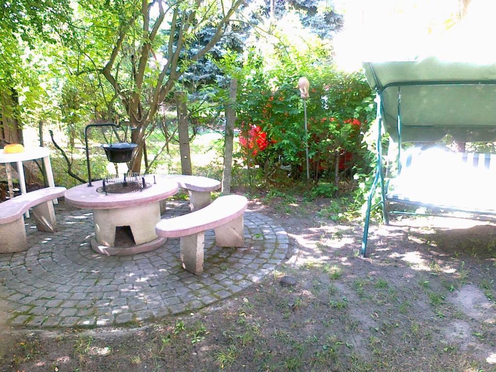 a group of benches sitting on a patio at Holiday home in Balatonfenyves 18465 in Balatonfenyves