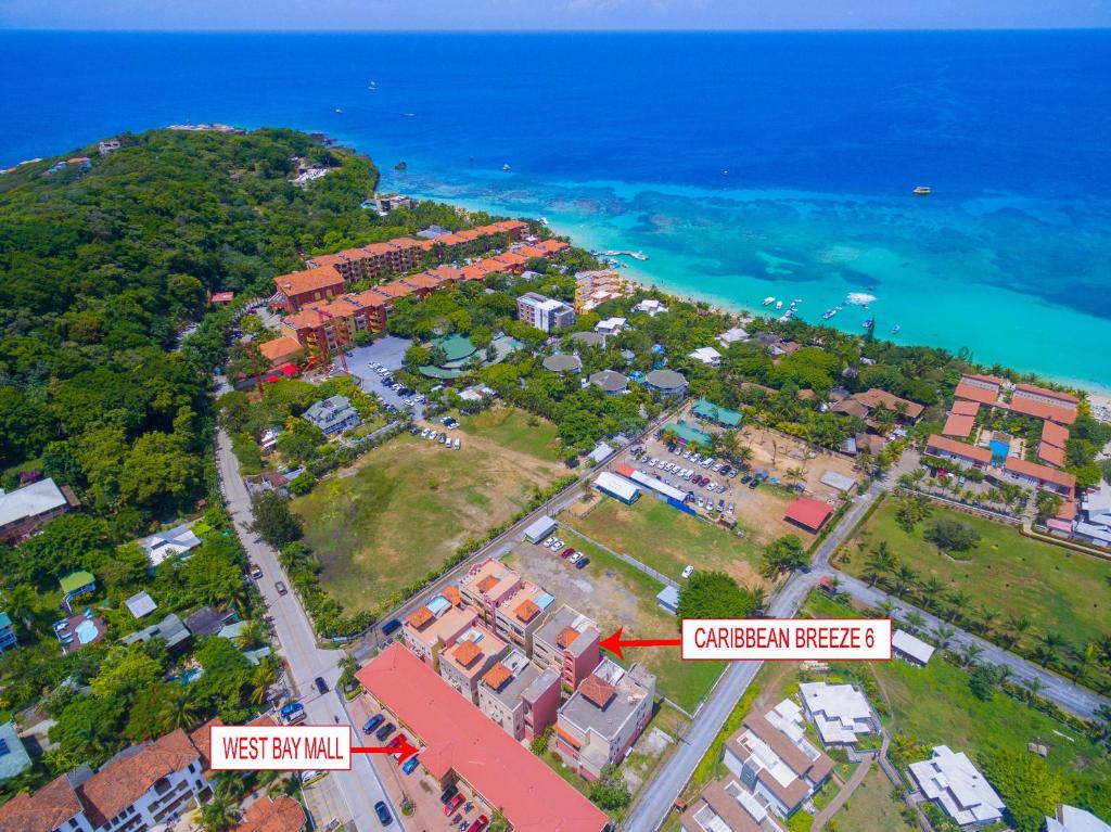 an aerial view of an island with houses and the ocean at Caribbean Breeze 6A Condo in Roatán