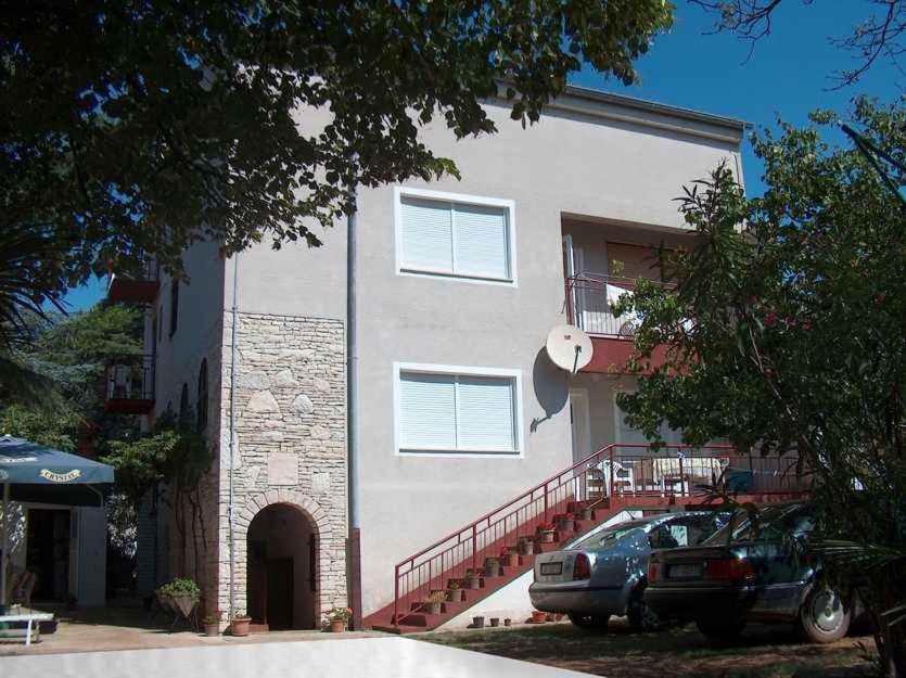 a building with a car parked in front of it at Apartment Medulin 12 in Medulin