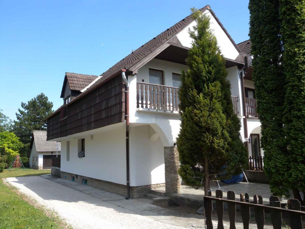 Cette maison blanche dispose d'un balcon et d'une clôture. dans l'établissement Holiday home in Gyenesdias/Balaton 18849, à Gyenesdiás