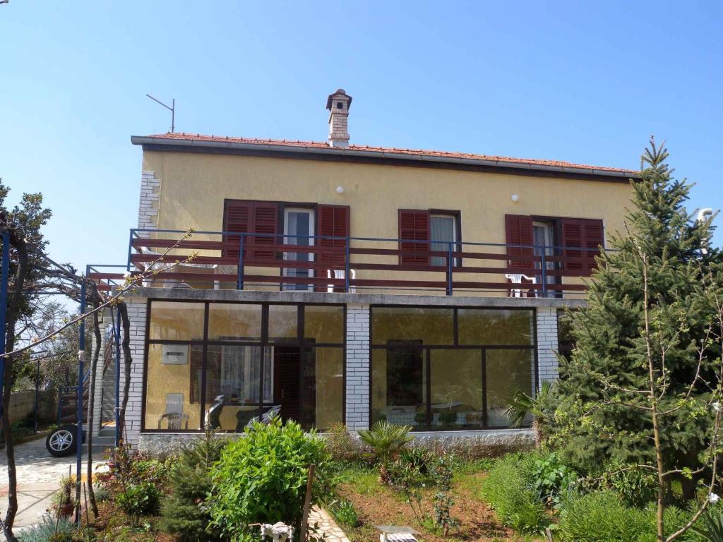 a house with a balcony on top of it at Apartment Fazana, Istria 16 in Fažana