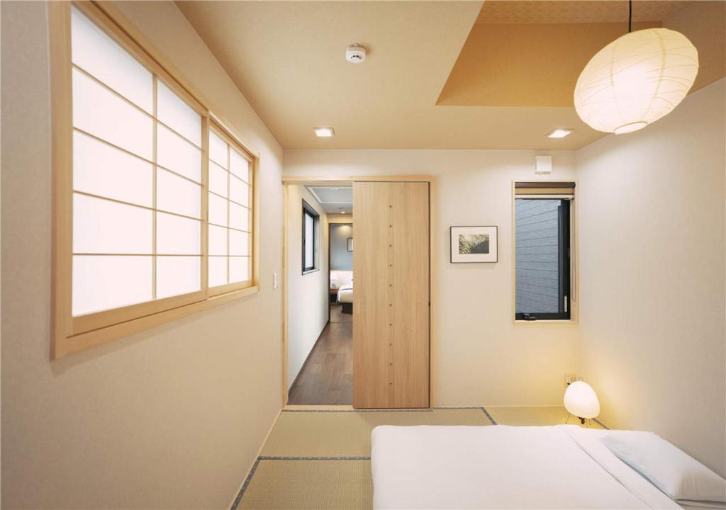 Postel nebo postele na pokoji v ubytování 谷町君・星屋・城下の宿