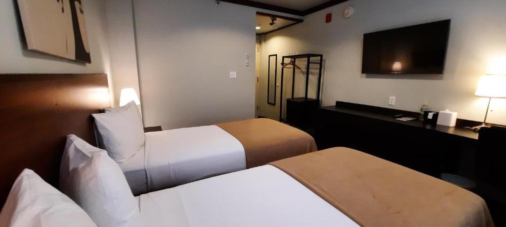 Postel nebo postele na pokoji v ubytování LIC Hotel