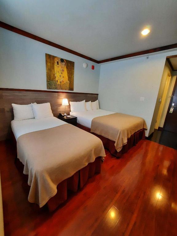 Ein Bett oder Betten in einem Zimmer der Unterkunft LIC Hotel