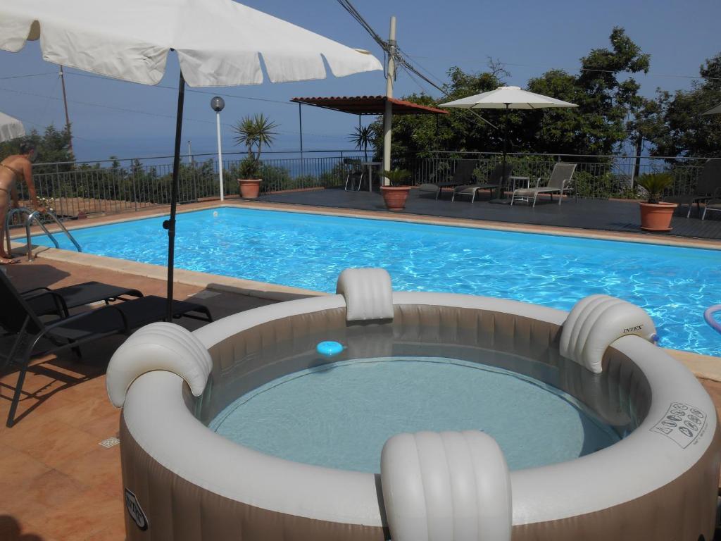 a swimming pool with a hot tub in front of it at Al Villino Sunrise in villa con piscina ed idromassaggio in SantʼAlfio