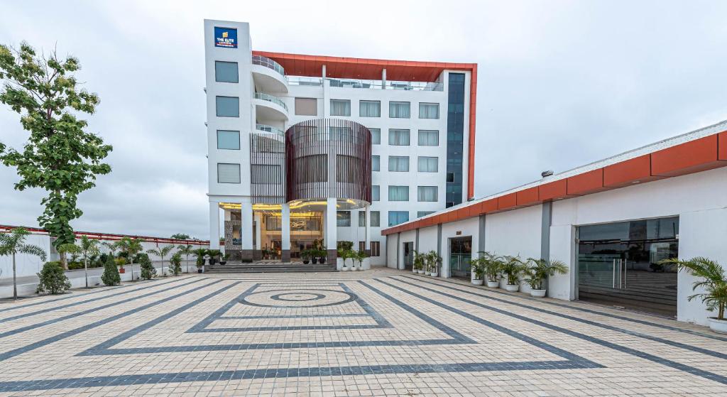 a large building with a large clock on the outside at The Elite Lucknow Convention Hotel in Lucknow