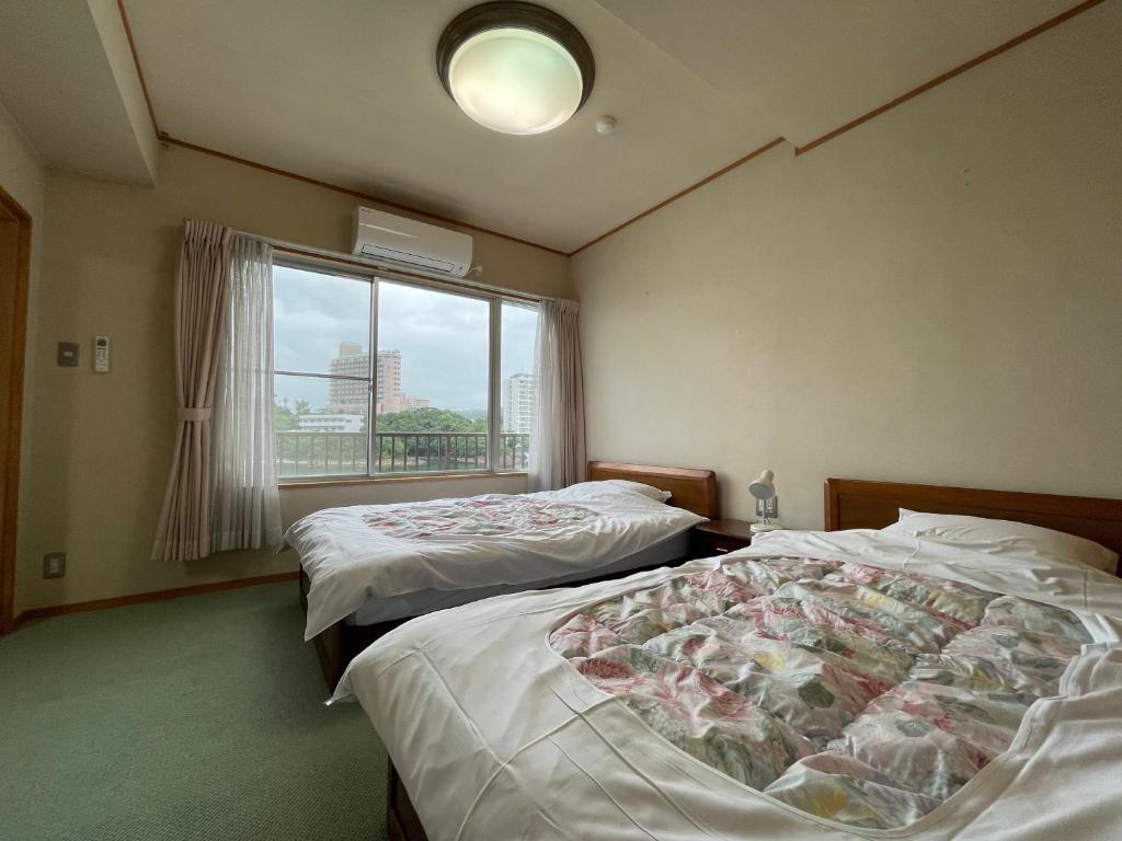 Postel nebo postele na pokoji v ubytování Marina Hotel Kaikuu