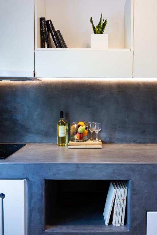 a table with a bottle of wine and a glass at Likio Studios in Batsi