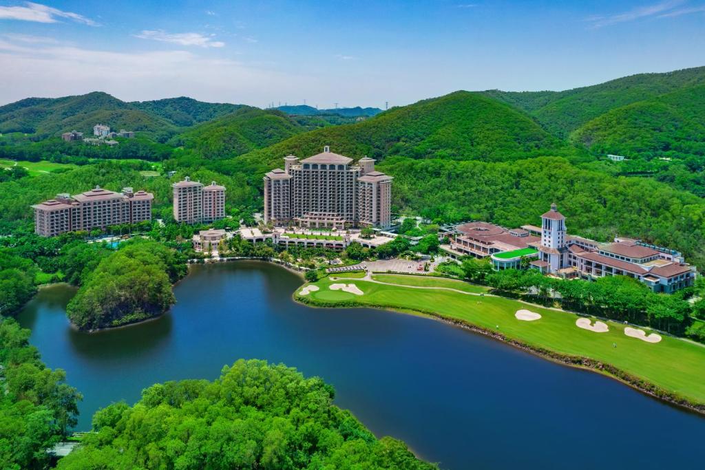 an aerial view of the resort and the river at Mission Hills Hotel Resorts Dongguan in Dongguan
