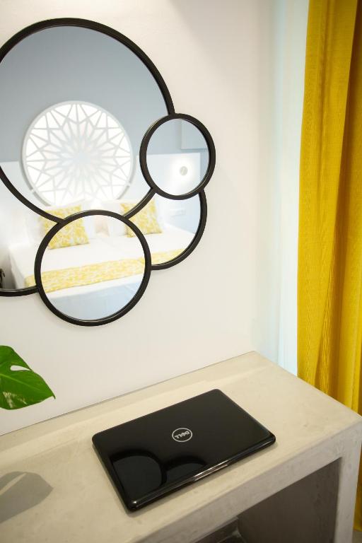 a laptop sitting on a table with a mirror at Likio Studios in Batsi
