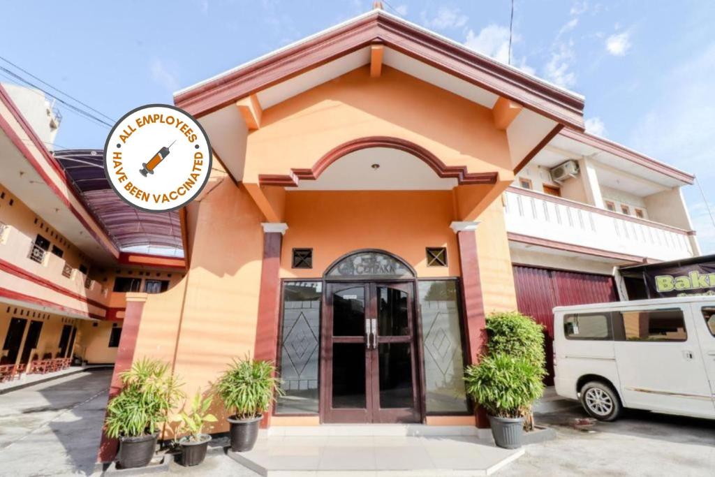 a building with a clock on the side of it at Cempaka Hotel in Yogyakarta