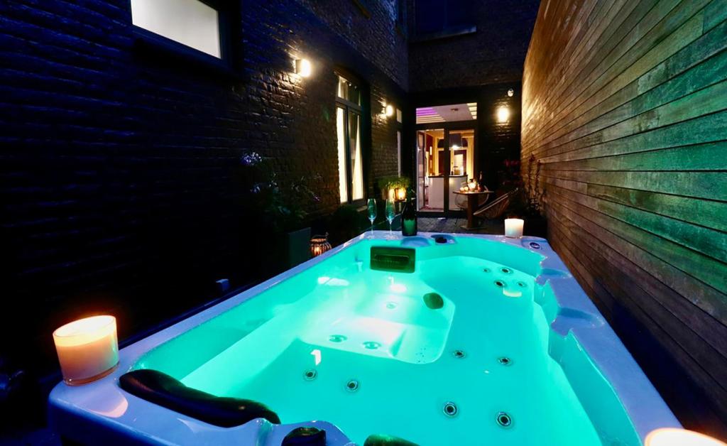 a jacuzzi tub in the middle of a room at SuiteDreams - Bubble Suite Liège in Liège