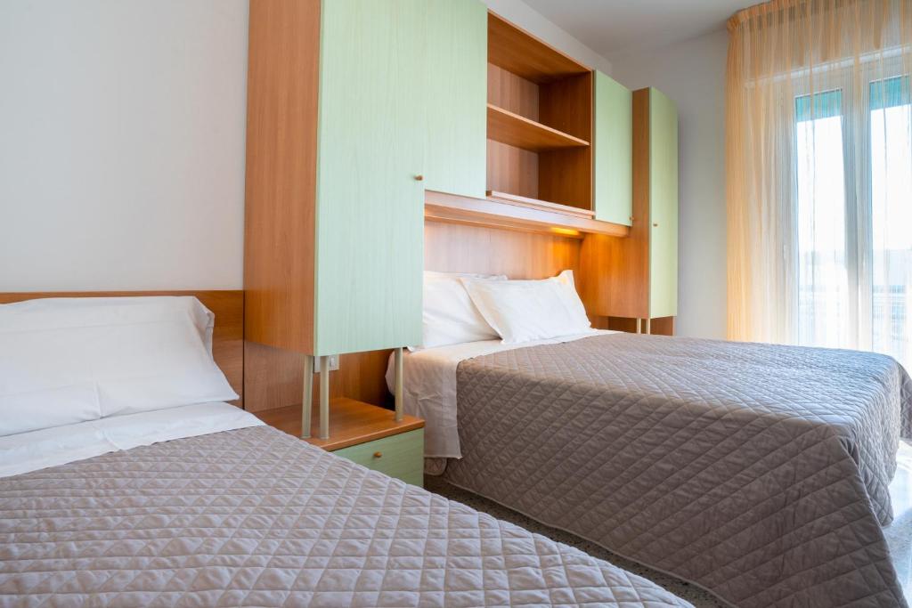 Postel nebo postele na pokoji v ubytování Hotel Dolomiti