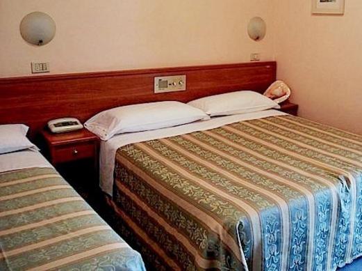 Postel nebo postele na pokoji v ubytování Hotel Acerboli