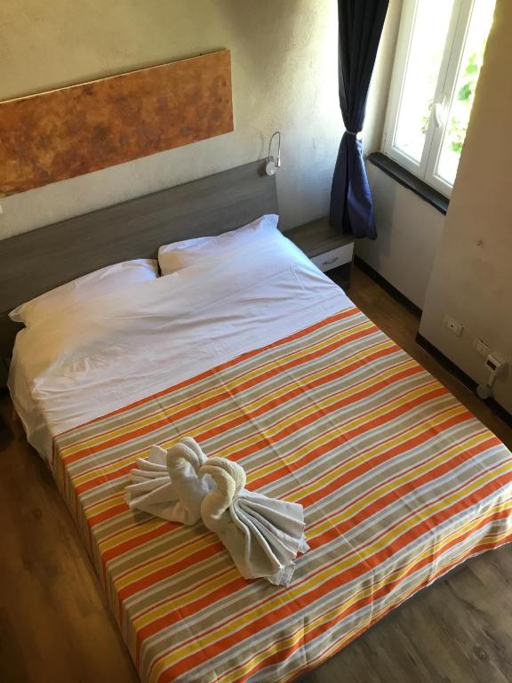 Postel nebo postele na pokoji v ubytování New Arcobaleno Ossegna