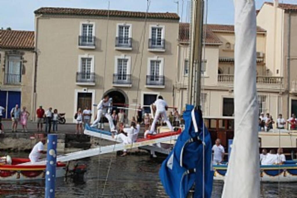 a group of people jumping off of boats in the water at Holiday Home With Pool In Marseillan in Marseillan