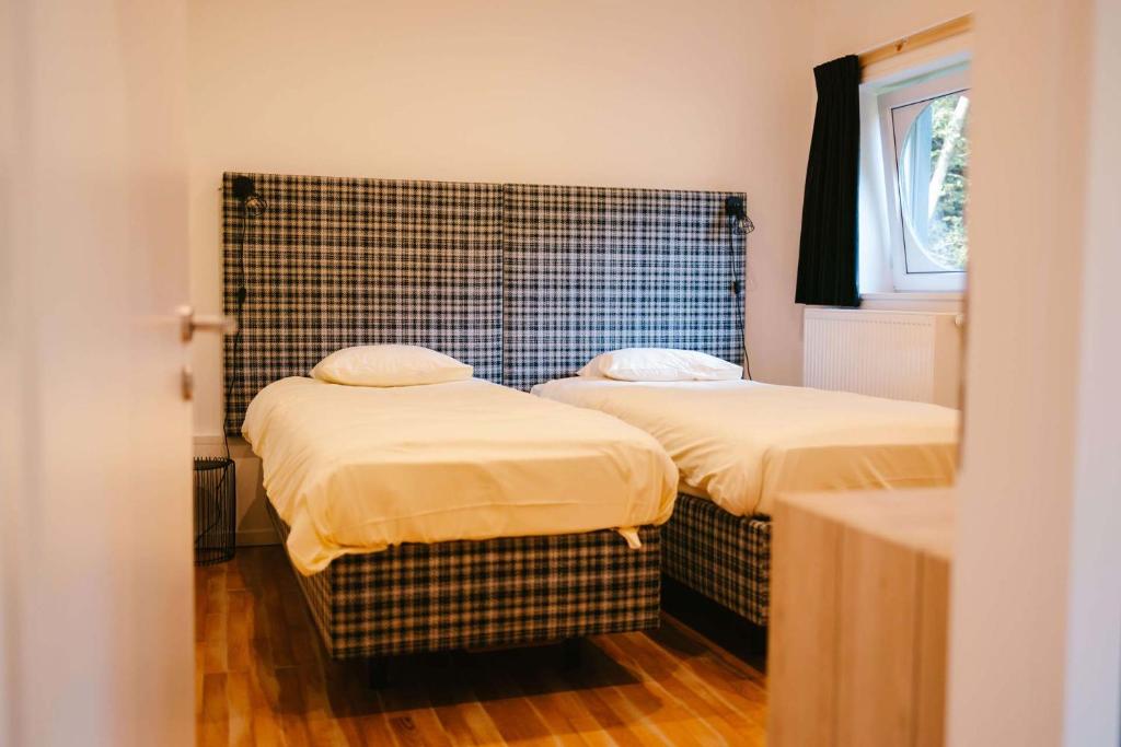 Postel nebo postele na pokoji v ubytování Hotel Le Val D'arimont