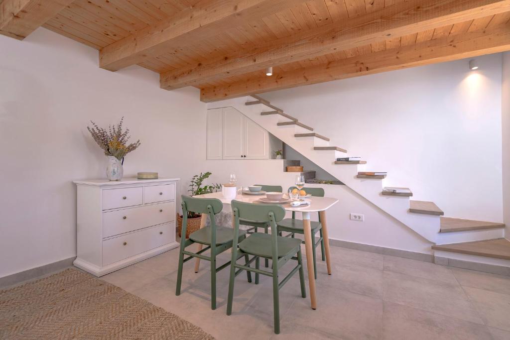a kitchen and dining room with a table and stairs at Villa Zanino in Veliko Grablje