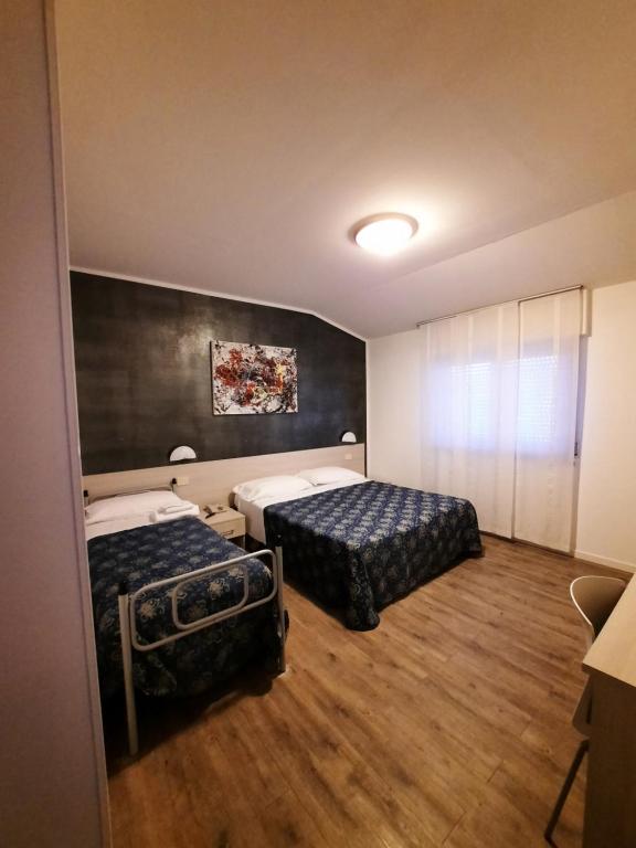 Postel nebo postele na pokoji v ubytování Hotel Rossi