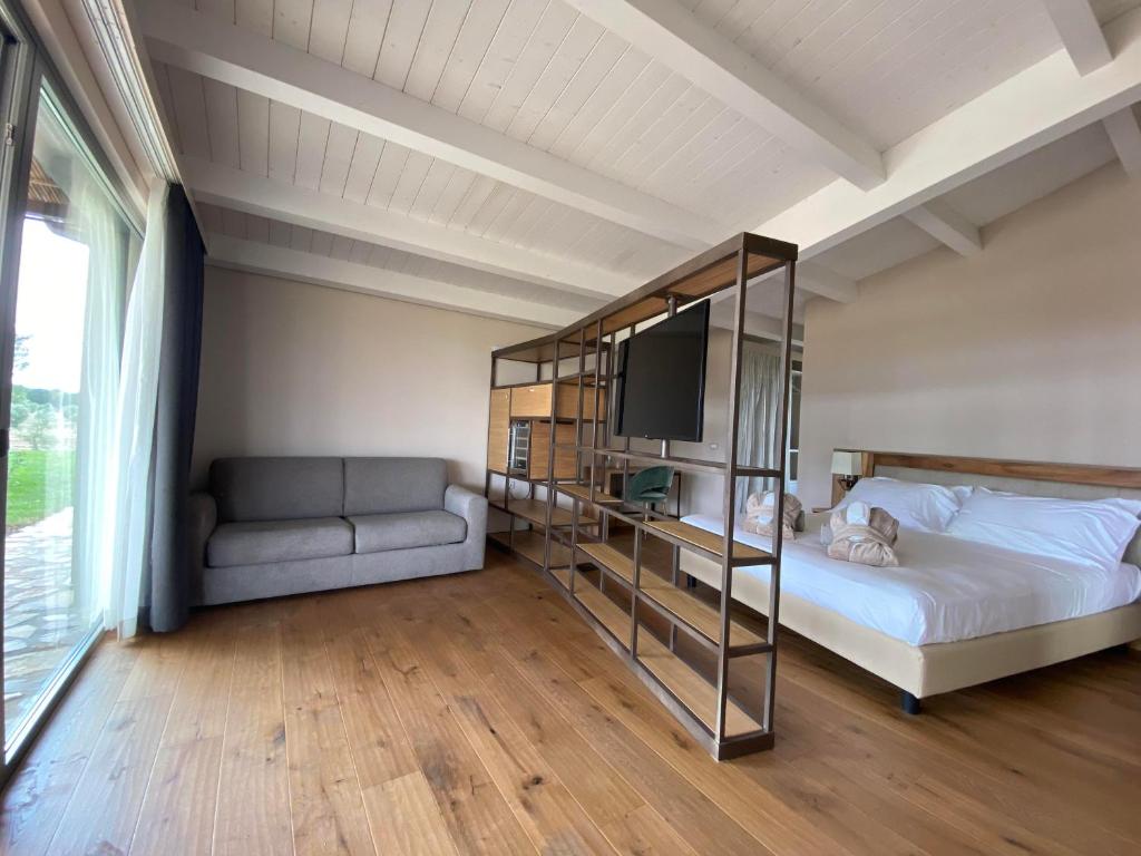 Posteľ alebo postele v izbe v ubytovaní Podere Maremma Spa & Ristorante