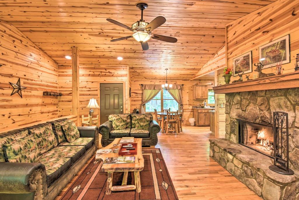 a living room with a couch and a fireplace at The Apple Dumpling Cabin Pool Table, Grill in Clarkesville