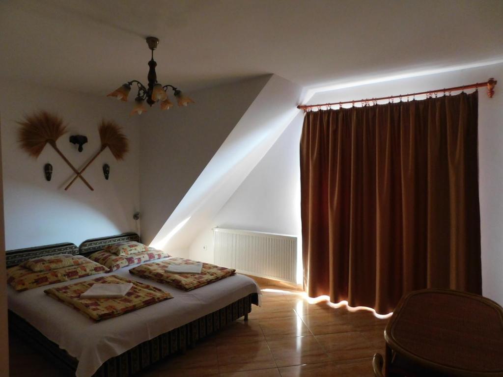 Postel nebo postele na pokoji v ubytování Szamóca Vendégház