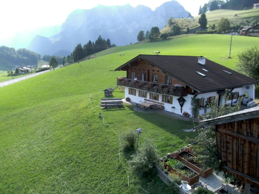 a house on a hill with a green field at Klettnerlehen in Ramsau