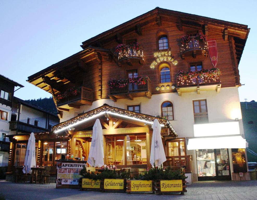 a store with umbrellas in front of a building at Hotel Helvetia in Livigno