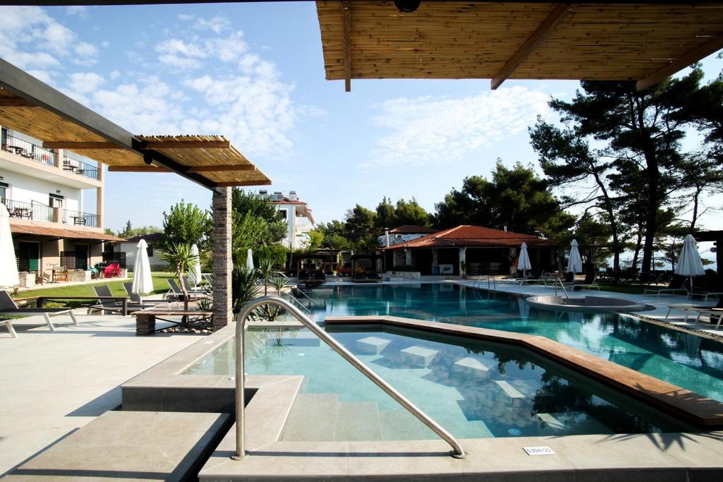 a swimming pool at a resort with a swimming pool at Nostos Hotel in Afitos