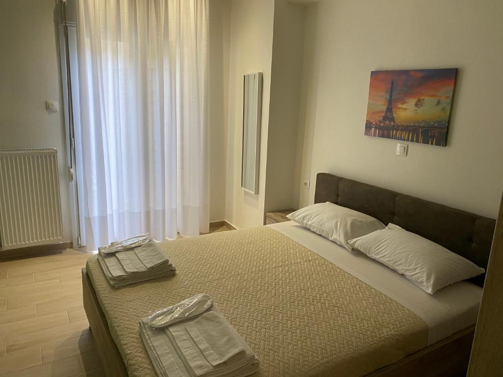 a bedroom with a bed with two towels on it at Great Alexander street, Larisa in Larisa