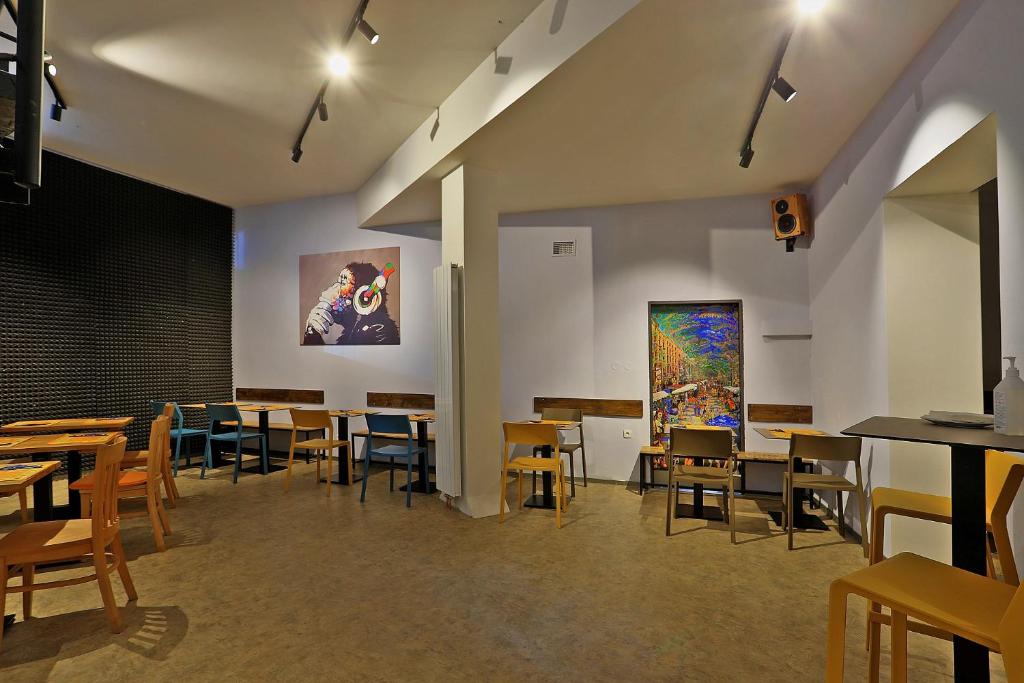 a room with tables and chairs and a painting on the wall at Hotel Pilgrim in Karlovy Vary