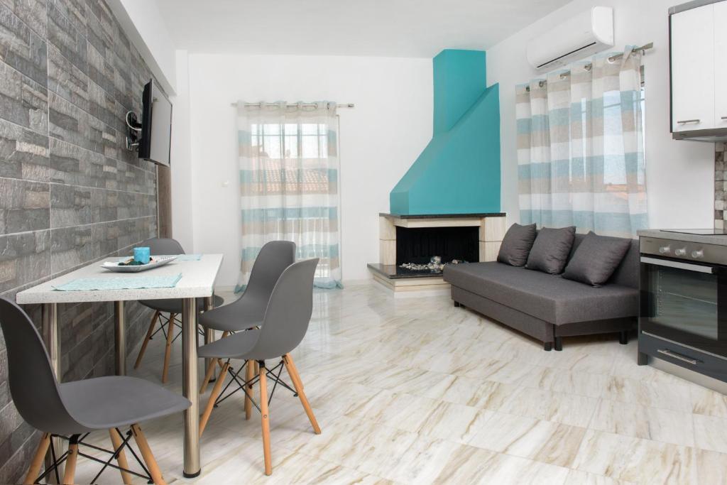 a living room with a couch and a table at XD Central Apartments in Ierissos