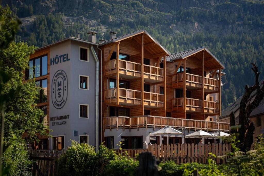 un hotel en las montañas con una montaña en Hôtel Restaurant Le Monêtier en Le Monêtier-les-Bains