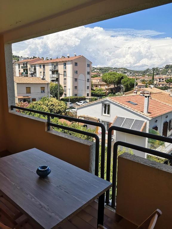 a balcony with a table and a view of a city at Studio with large balcony and nice view by Weekome in Vallauris