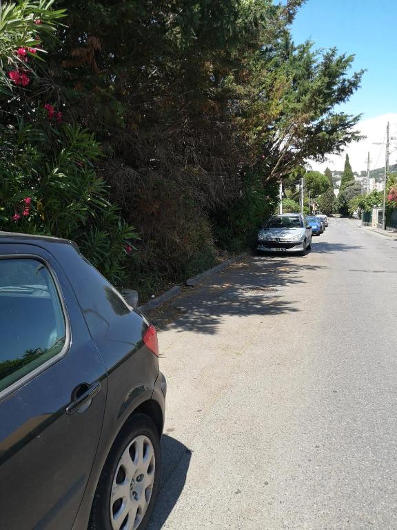 a row of cars parked on the side of a street at Studio with large balcony and nice view by Weekome in Vallauris