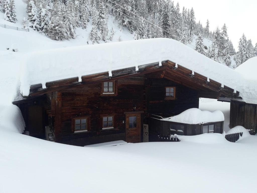 a log cabin with snow on the roof at Hüttenzeit almhütte sölden in Sölden