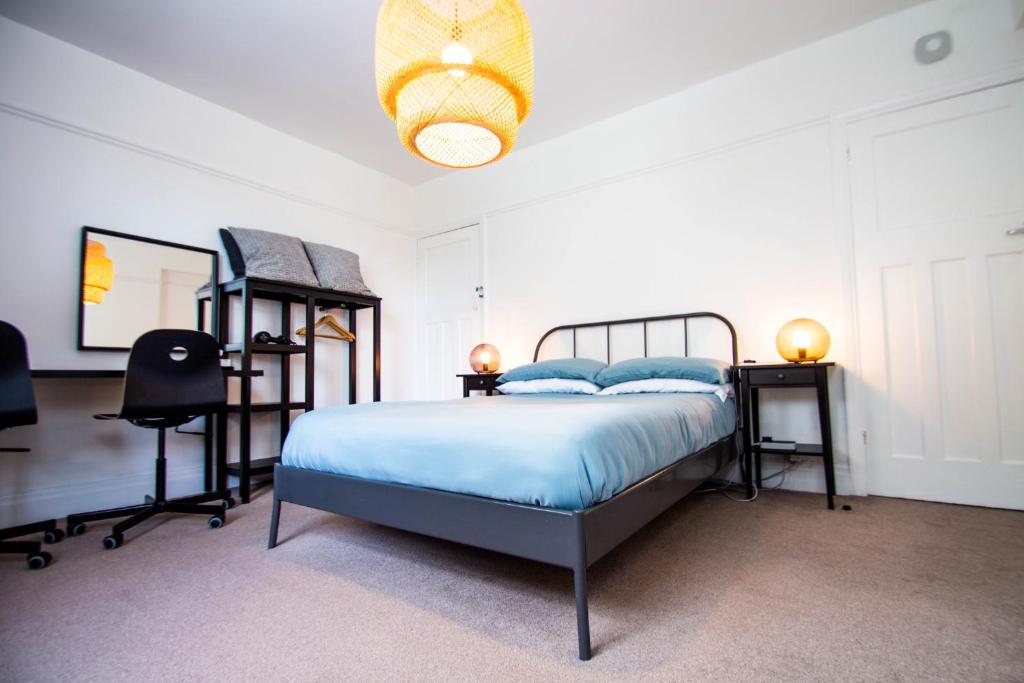 a bedroom with a bed and two bunk beds at Peaceful House in the Centre of City in Lancaster