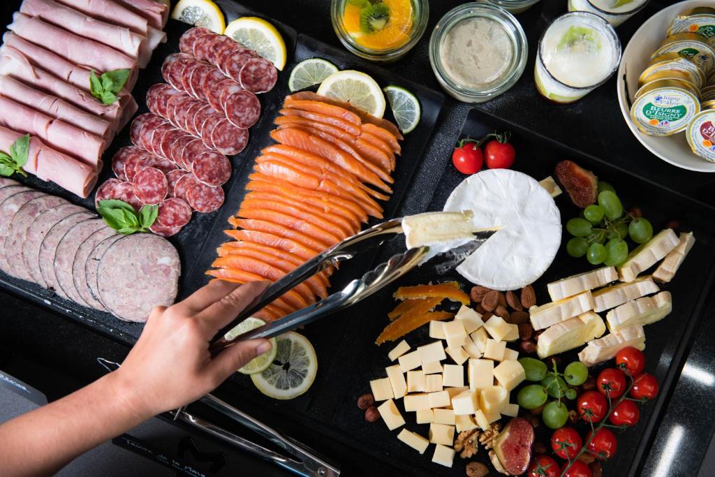 a tray of different types of meats and vegetables at YOU Are Deauville in Deauville