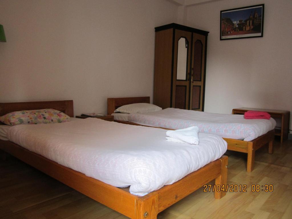 Cama ou camas em um quarto em Le Rhododendron Chambres D'hotes
