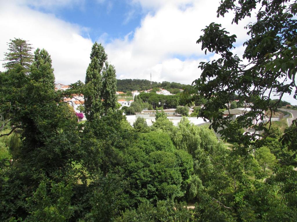 a view of a town through the trees at Casa Rosa em Monchique in Monchique