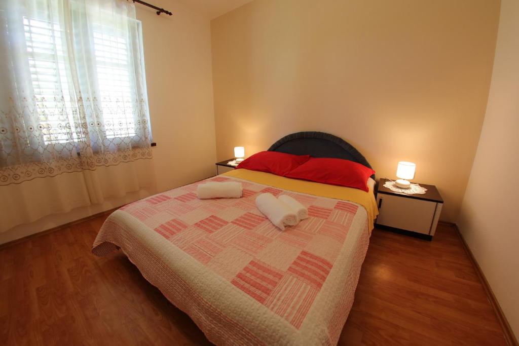 a bedroom with a bed with two towels on it at Apartments Vedrana in Zadar